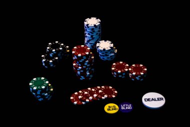 Siyah arkaplanda poker çipleri yığını