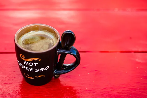 Cup of fresh made coffee on wooden background