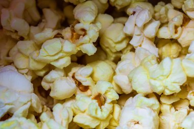 Makro, tereyağlı patlamış mısır üzerine seçici bir odaklanma. Patlamış mısır arkaplanı