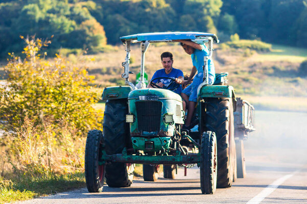Agricultural tractor on road in Viscri, Romania, 2021