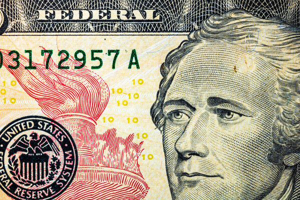 Selective focus on detail of USD banknotes. Close up macro detail of United States Dollars banknotes. World money concept, inflation and economy concept