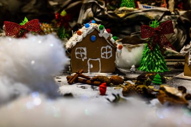 Renkli zencefilli kurabiye evi, bulanık arka planda, Noel süslemesiyle izole edilmiş..