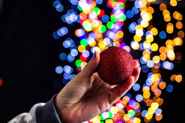 Holding Christmas Bauble Decoration Isolated Background Blurred Lights December Season — Stock Photo, Image