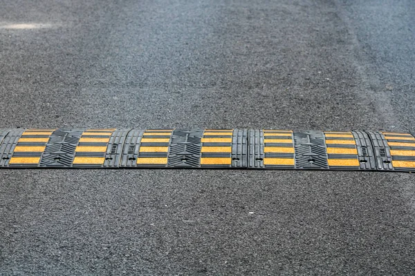 Traffic safety speed bump on an asphalt road in a parking area in Bucharest, Romania, 2020