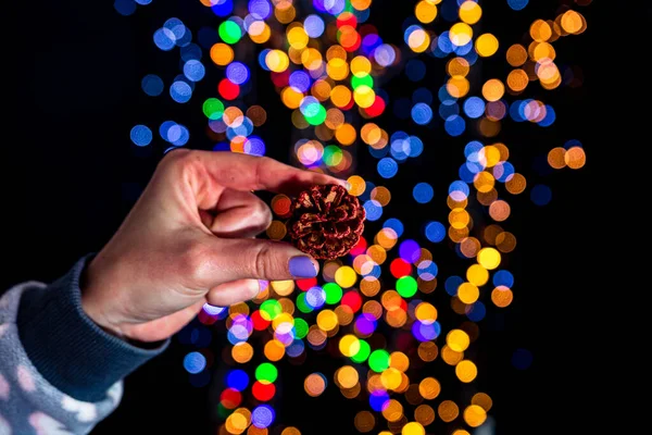 Holding Christmas Pine Cone Decoration Isolated Background Blurred Lights December — Stock Photo, Image