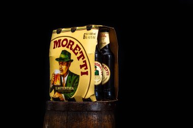 6 paket Birra Moretti birası. Koyu arkaplanlı ahşap fıçı üzerinde. Bükreş, Romanya, 2021
