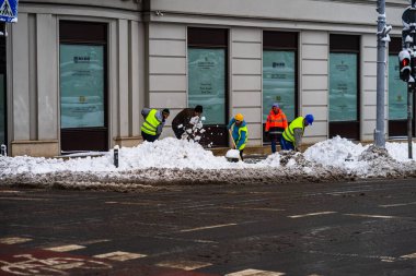 Romanya 'nın Bükreş kentindeki karlı yolu temizleyen kar temizleme ve işçi 2021