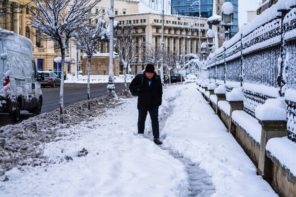 Walking on snowy trail in Bucharest, Romania, 2021. Snow on streets, snowy road, winter day