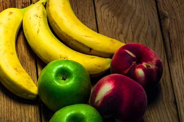 Mix of fresh fruits on wooden table