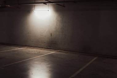 Boş yer altı garajı. Boş park yeri ve loş ışık