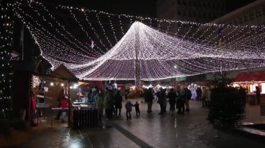 Targoviste Noel Pazarı. Şehir meydanında süslü ağaçlar ve şenlikli ışıklar var. İnsanlar Noel Pazarı 'nı seviyor