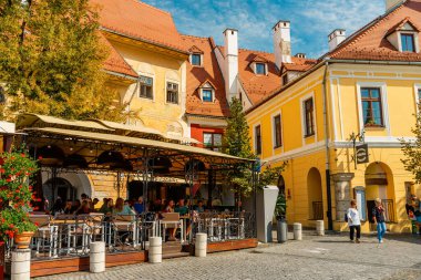 People wandering through the medieval streets of old town Sibiu Romania during summer travel