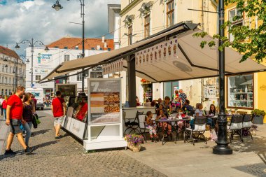 People wandering through the medieval streets of old town Sibiu Romania during summer travel