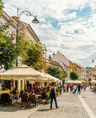 People wandering through the medieval streets of old town Sibiu Romania during summer travel