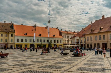 People wandering through the medieval streets of old town Sibiu Romania during summer travel