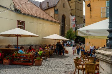 People wandering through the medieval streets of old town Sibiu Romania during summer travel