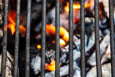 Barbekü ızgarası, yanan odun ve ateş alevleri. Parlak alevli boş kömür ızgarası.