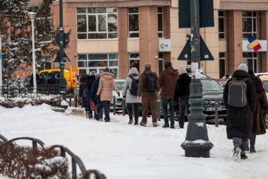 Bükreş 'te karlı bir yolda yürüyen insanların olduğu kentsel kış sahnesi