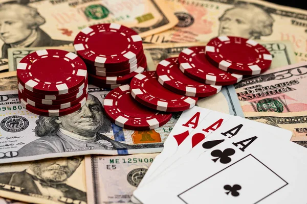 Amerikan dolarları üzerine yığılmış poker fişleri ve kumarhaneyi temsil eden kâğıtlar ve riskler