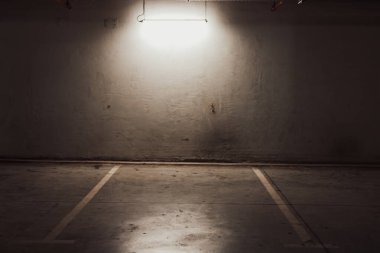 Boş yer altı garajı. Boş park yeri ve loş ışık