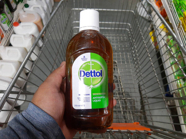 Дели, Индия - 5 октября 2020 года: руки держат большую бутылку дезинфицирующего средства для рук Деттола