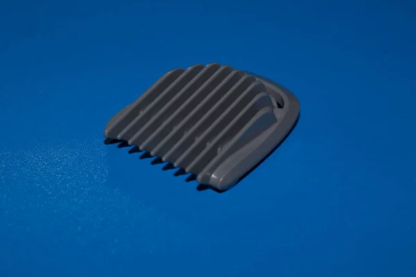 Hair trimmer isolated on the blue background. Beard and hair clippers.