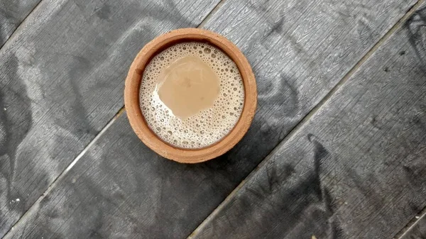 A kulhar or kulhad cup (traditional handle-less clay cup) from North India filled with hot Indian tea