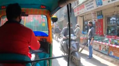 Otomobil Rickshaw (Tuk Tuk) 'un içinde Chandni Chowk Caddesi' nde trafik ve insan dolu arka koltuktan ateş edildi.