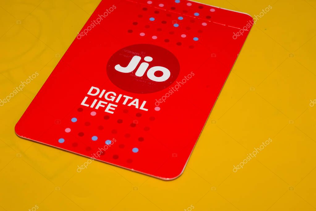 Delhi, India - June 05, 2020 : Jio SIM Cards With Every JioFi or 4G Smartphone with Yellow Background for text