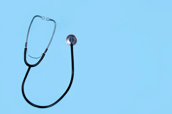 Medical concept. Top view of a stethoscope on a blue background. Flat lay and copy space.