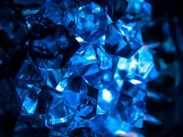 stock image Bright blue crystals made of glass look like gems close-up in the blur. Background from blue stones crystals.