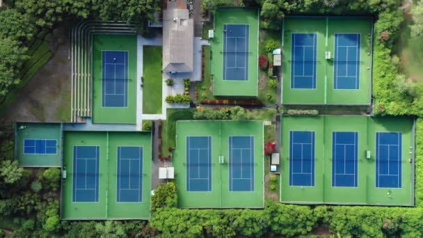 Antenn tennis bakgrund 4K. Top down vy på många tennisbanor med människor — Stockvideo