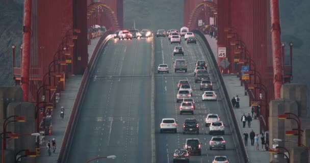 Close up view on evening traffic on Gold Gate Bridge. Police car is closing lane — Stock video
