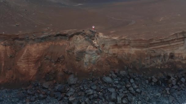 Man standing on rock of Capelinhos Volcano, Faial Island, Azores, Portugal — Stockvideo
