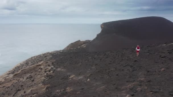 Man exploring volcanic area of Capelinhos Volcano, Faial Island, Azores — Stock Video