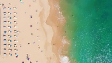 Yellowish sand surrounded with turquoise sea waters as seen from above