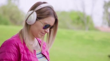 Young woman wearing wireless headphones e-learning, distance online education 8K