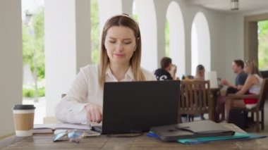 Young caucasian business woman with headphones communicating video call, RED 8K