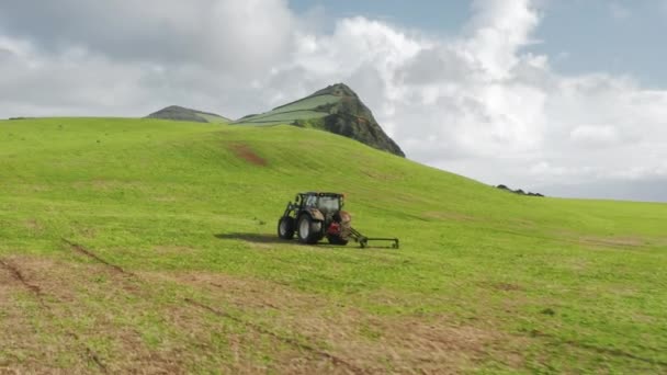 Tractor plowing fields on volcanic island of Sao Jorge, Azores, Portugal, Europe