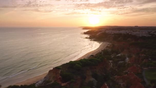 Aerial shot over peaceful, calm seascape with beautiful sunset behind — Stock Video