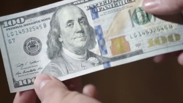 Un billete de cien dólares en manos de hombres. primer plano — Vídeo de stock