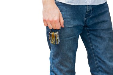 Bir sürü anahtarı olan kot pantolonlu bir adamın bacakları.