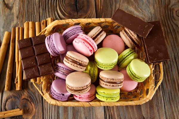 Bitter çikolata, toz kakao, Fransız macaron ve tarçın ahşap tablo