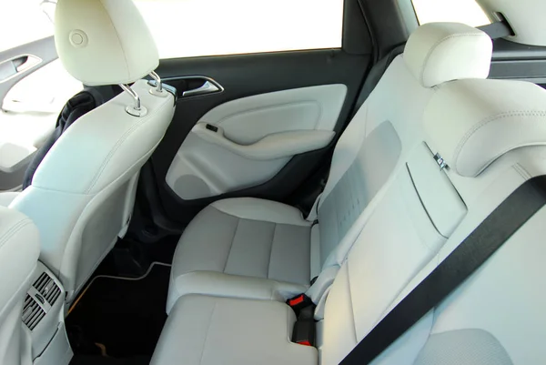 The white rear seat of a luxury passenger car