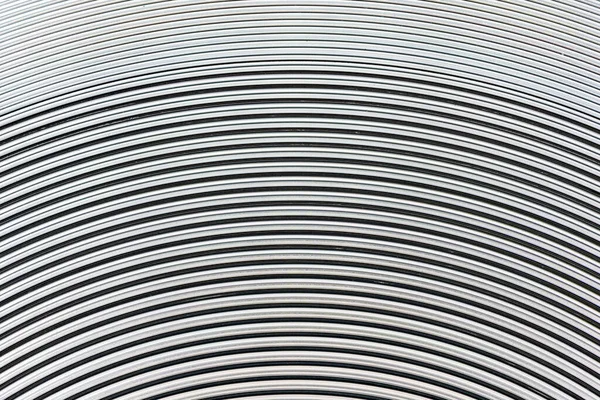 Sarmal desenli alüminyum metal yüzey yakın çekim fotoğraf arkaplanı.