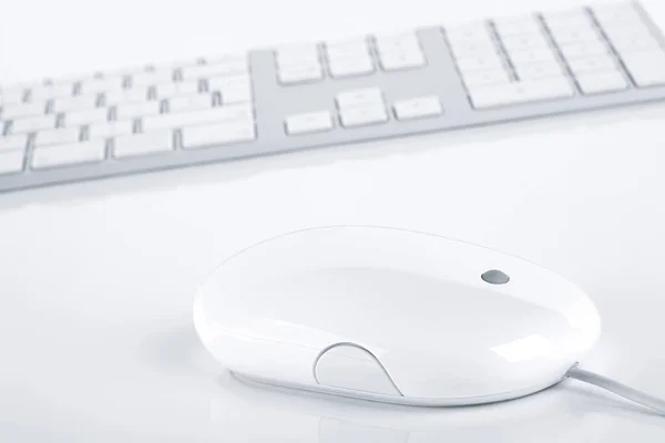 White computer keyboard and mouse. Tidy and minimalistic design.