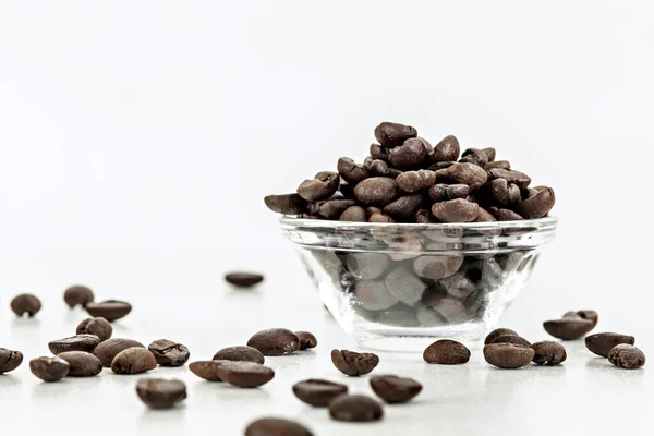Roasted coffee in bowl. Coffee seeds.