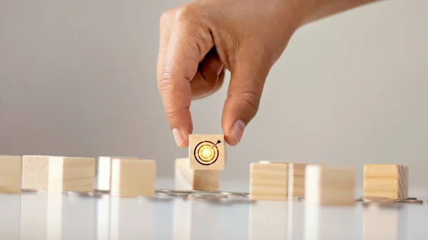Hand-picked wooden cube with virtual targets and targets. business success goals financial concept and business growth