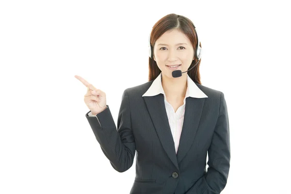 Closeup portrait of young female call center operator with a headset — Stock Photo, Image