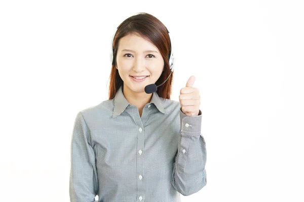 Closeup portrait of young female call center operator with a headset — Stock Photo, Image